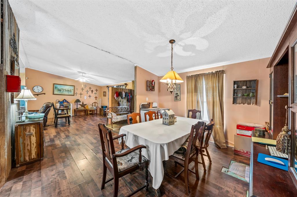 236 Bode Road Elm Mott, TX 76640 - Photo 11 of 33 a view of a dining room and livingroom with furniture wooden floor a rug a flat screen tv a rug and a chandelier