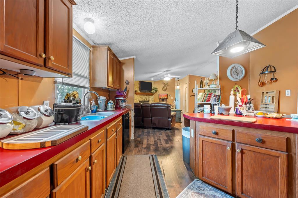 236 Bode Road Elm Mott, TX 76640 - Photo 13 of 33 a kitchen with stainless steel appliances granite countertop a sink and cabinets