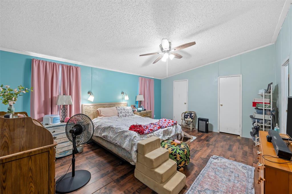 236 Bode Road Elm Mott, TX 76640 - Photo 17 of 33 a bedroom with a bed and a chandelier