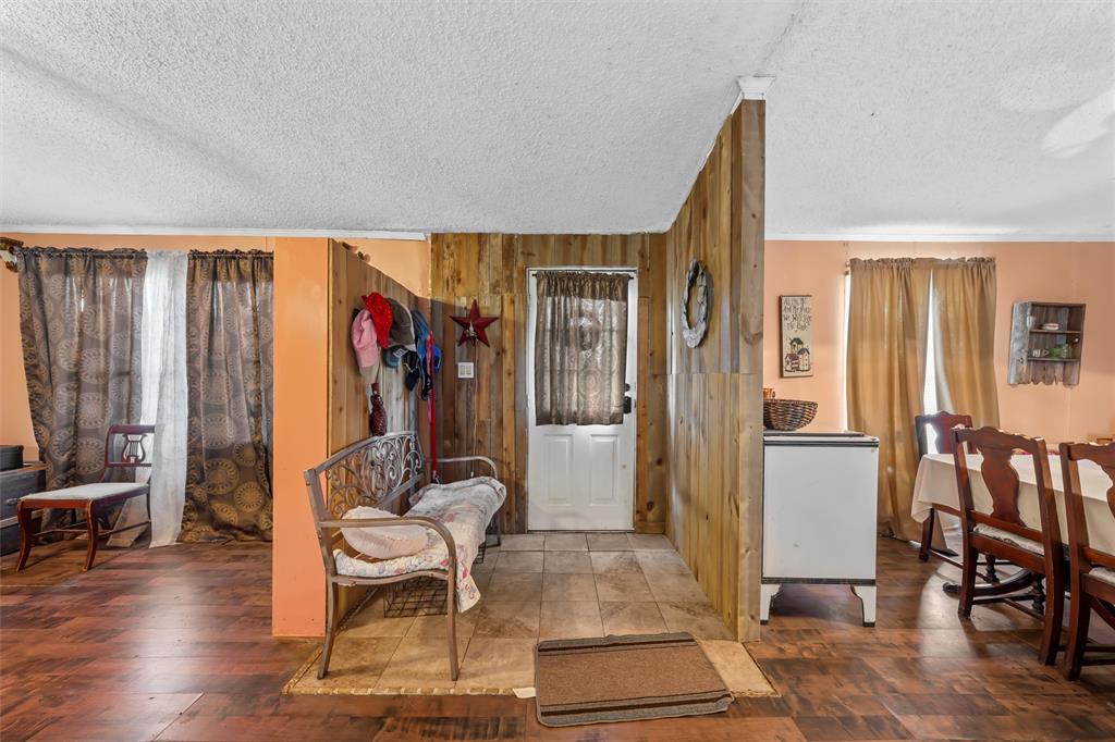 236 Bode Road Elm Mott, TX 76640 - Photo 4 of 33 a living room with furniture a dining table and a refrigerator