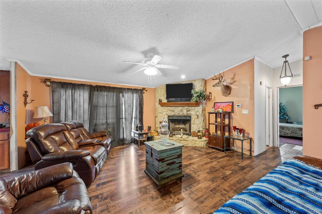 236 Bode Road Elm Mott, TX 76640 - Photo 5 of 33 a living room with furniture and a fireplace