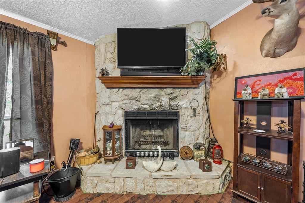 236 Bode Road Elm Mott, TX 76640 - Photo 6 of 33 a living room with furniture and a fireplace