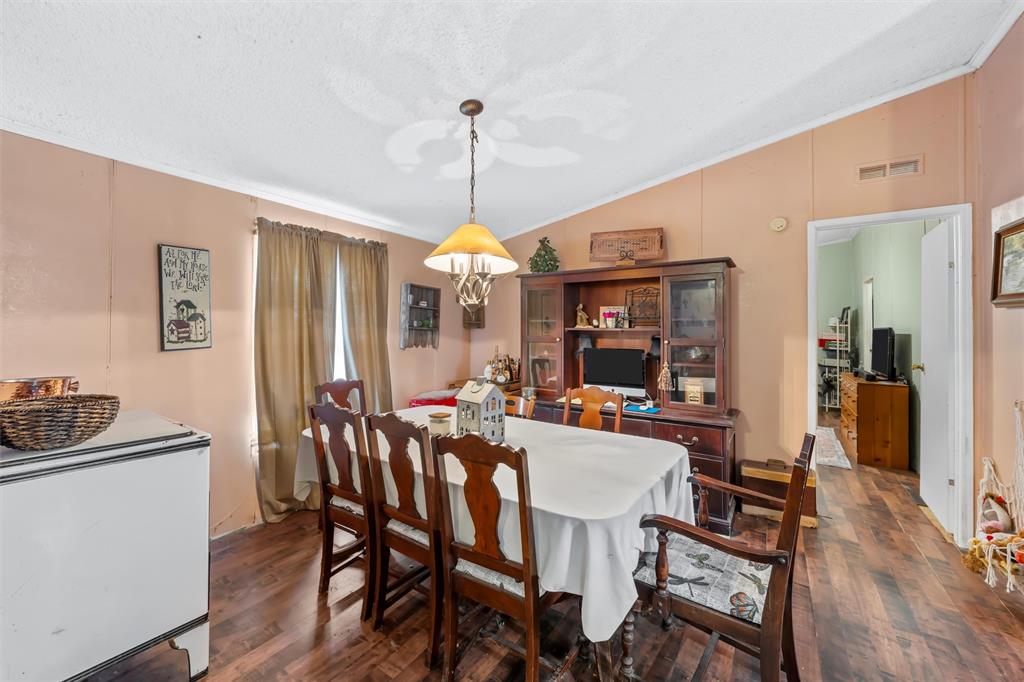 236 Bode Road Elm Mott, TX 76640 - Photo 10 of 33 a view of a dining room with furniture window and wooden floor