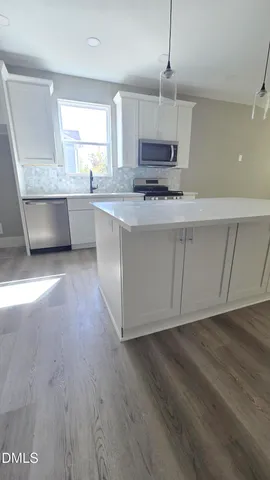 a bathroom with a granite countertop toilet and a sink