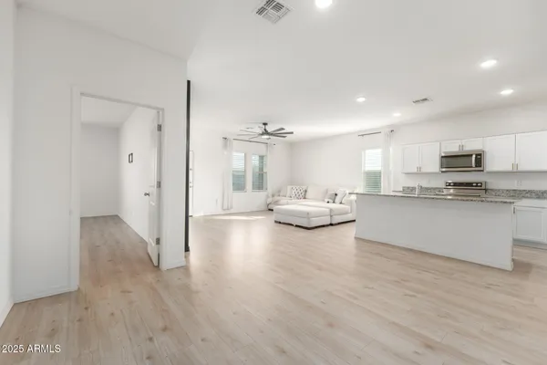 a living room with furniture and kitchen view