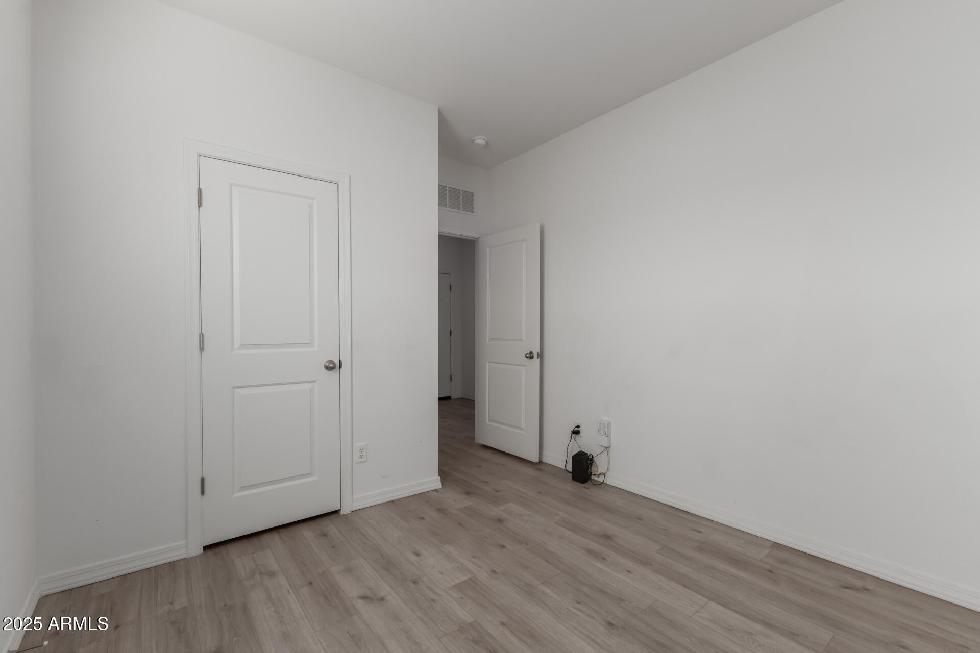 8133 South 64th Lane Laveen, AZ 85339 - Photo 24 of 32 a view of an empty room with wooden floor