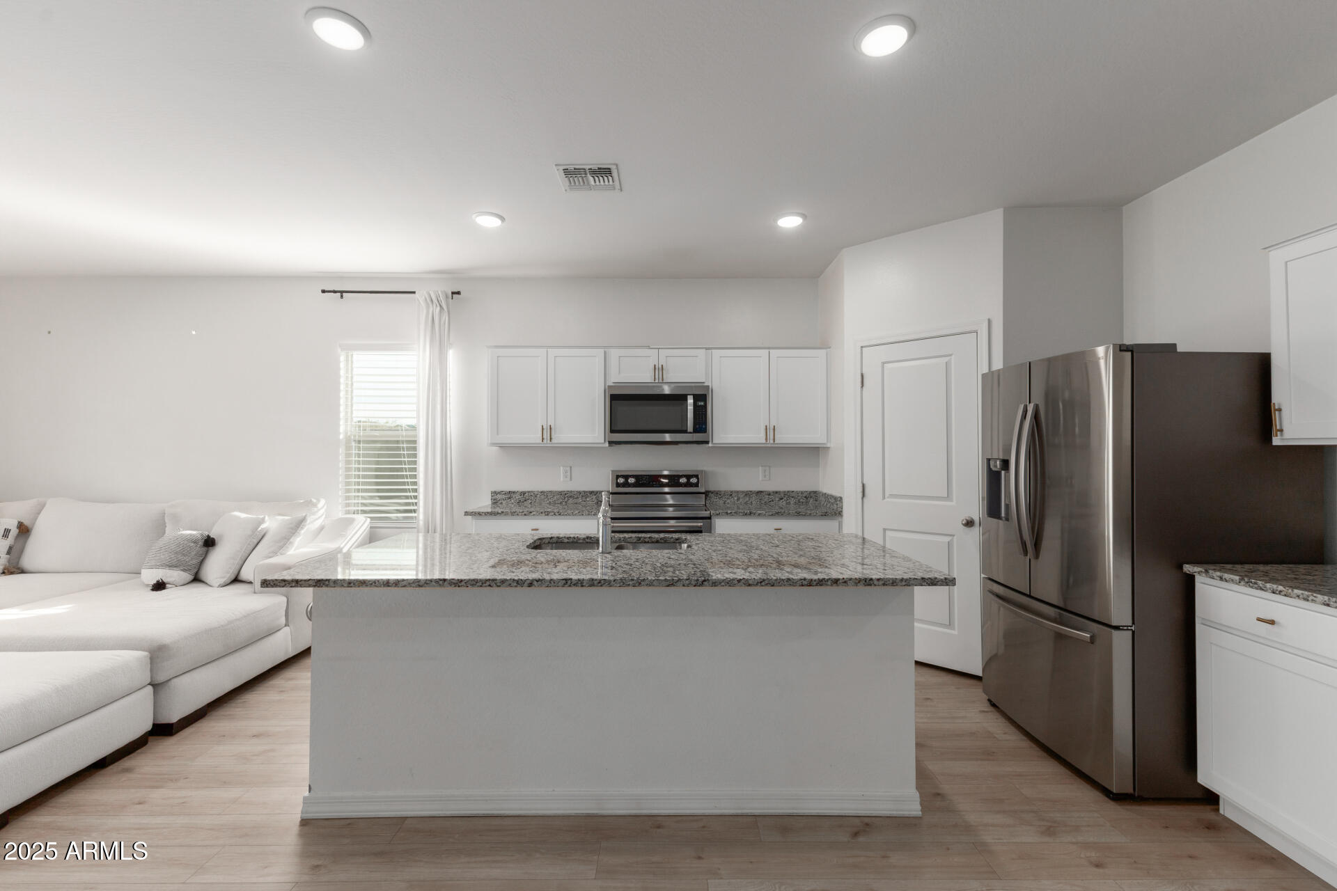 8133 South 64th Lane Laveen, AZ 85339 - Photo 4 of 32 a large kitchen with granite countertop a large counter top stainless steel appliances and cabinets