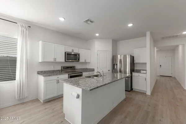 a kitchen with a sink stove and refrigerator