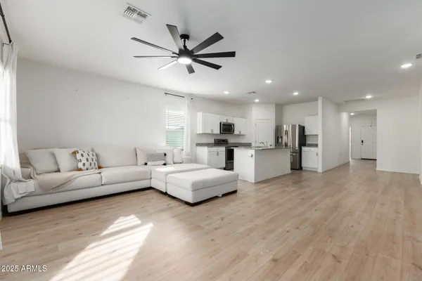 a living room with furniture and kitchen view