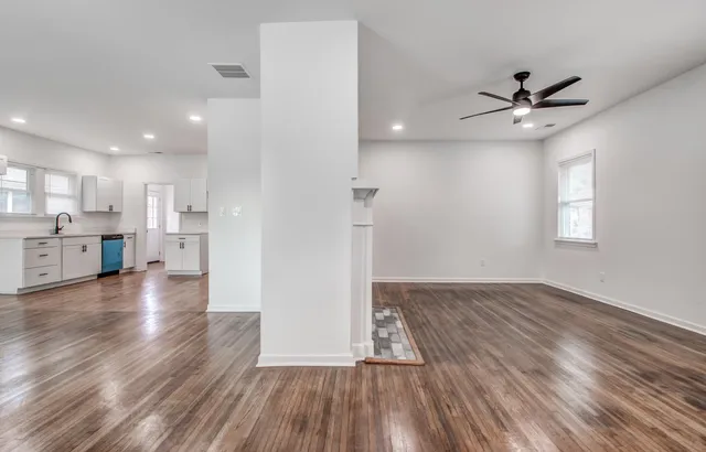 a view of a kitchen with wooden floor and a kitchen
