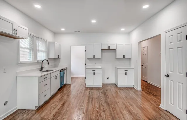 a kitchen with white cabinets and stainless steel appliances