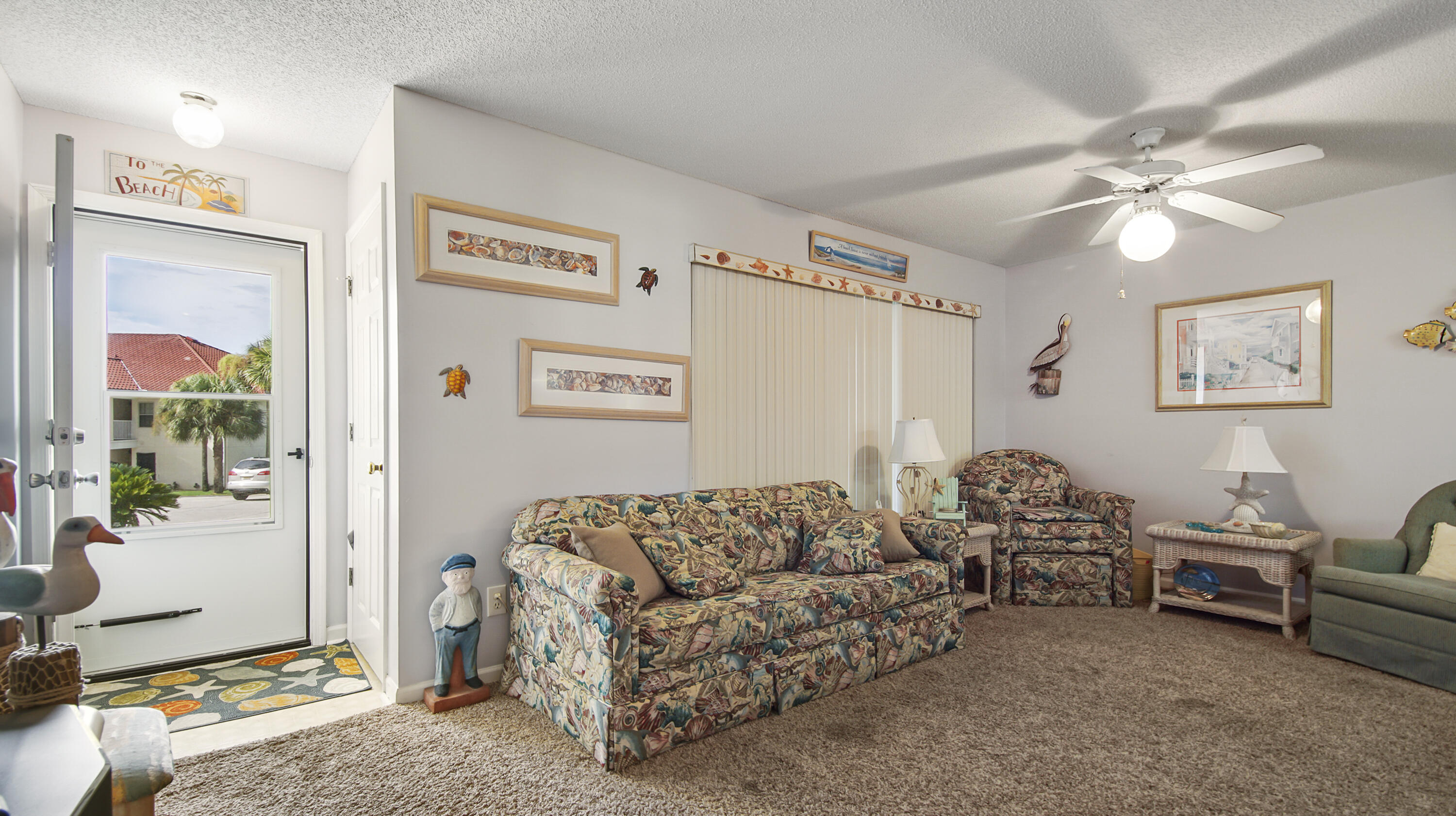 17462 Front Beach Road, Unit 54106 Panama City Beach, FL 32413 - Photo 15 of 32 a living room with furniture and a chandelier