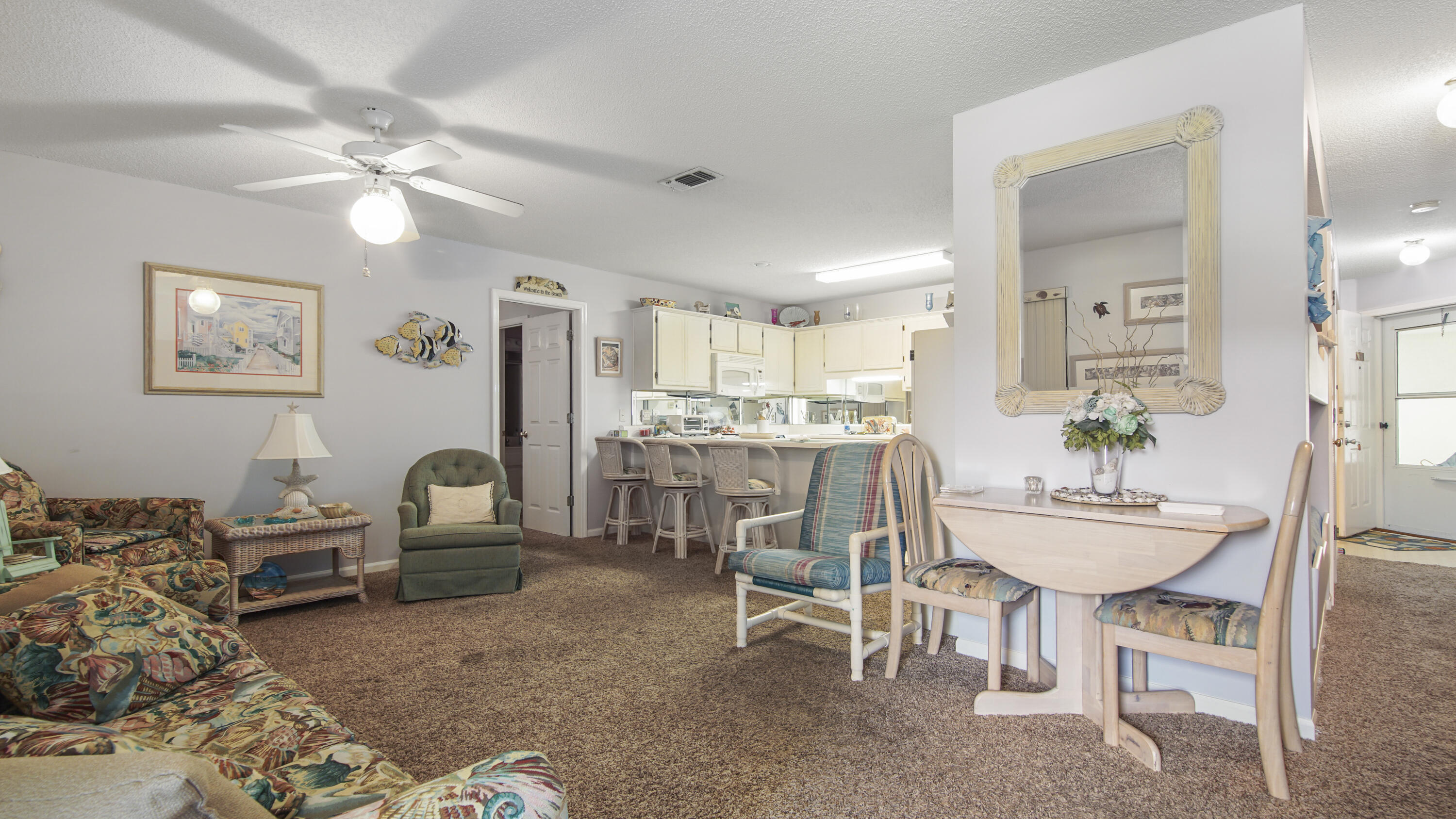 17462 Front Beach Road, Unit 54106 Panama City Beach, FL 32413 - Photo 18 of 32 a dining room with wooden floor and chandelier