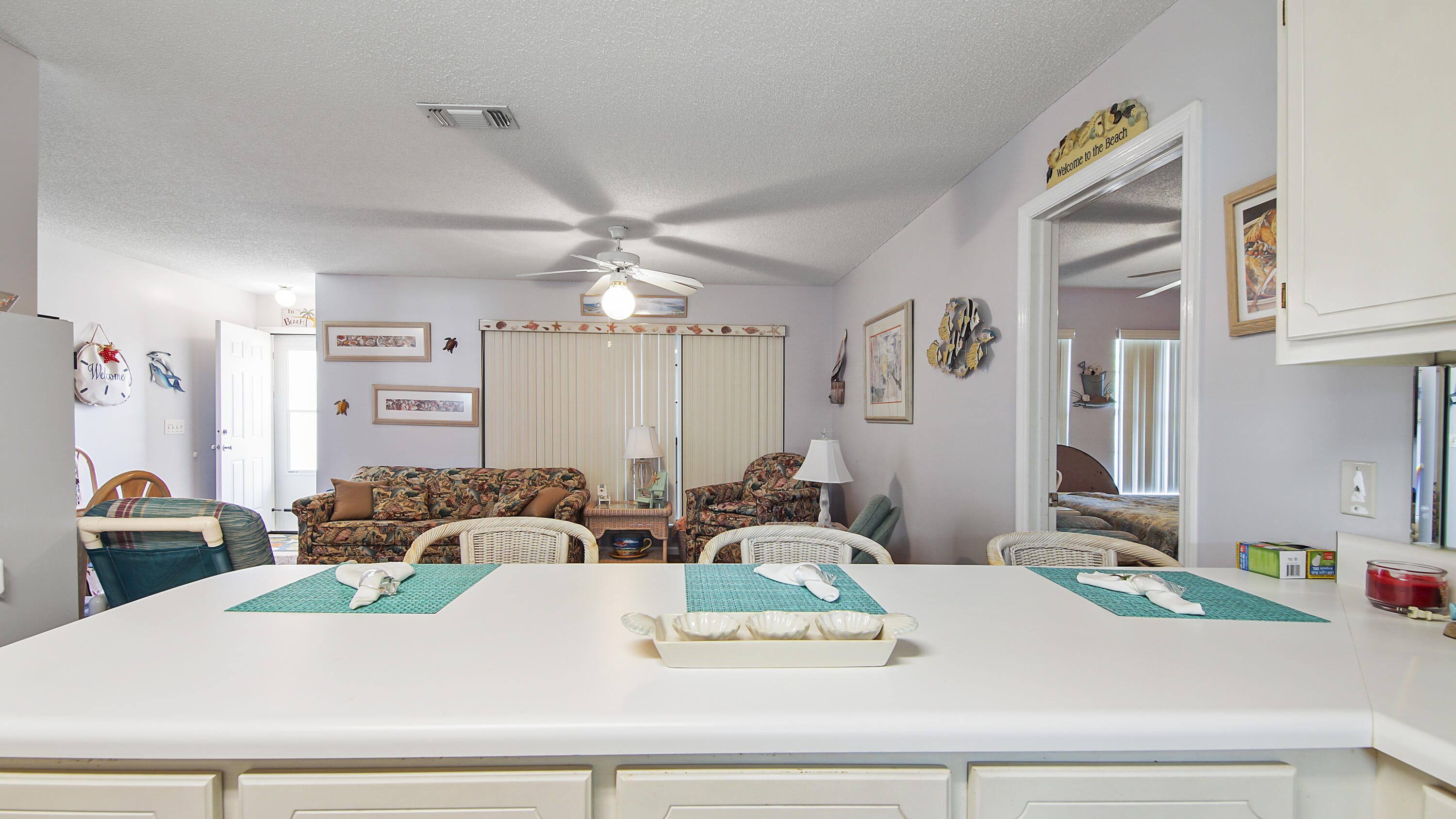 17462 Front Beach Road, Unit 54106 Panama City Beach, FL 32413 - Photo 22 of 32 a living room with furniture and a chandelier