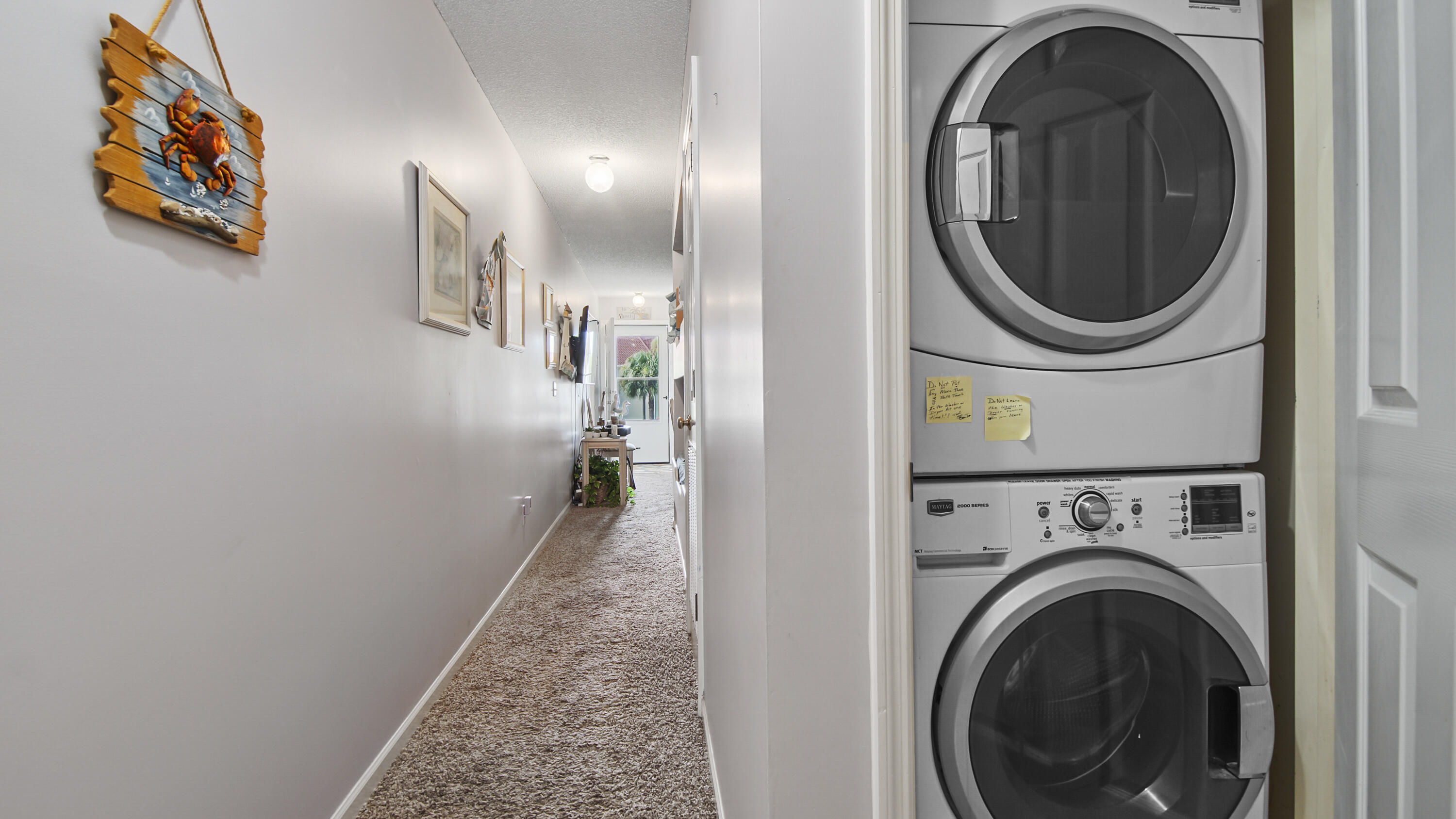17462 Front Beach Road, Unit 54106 Panama City Beach, FL 32413 - Photo 24 of 32 a view of a hallway with washer and dryer