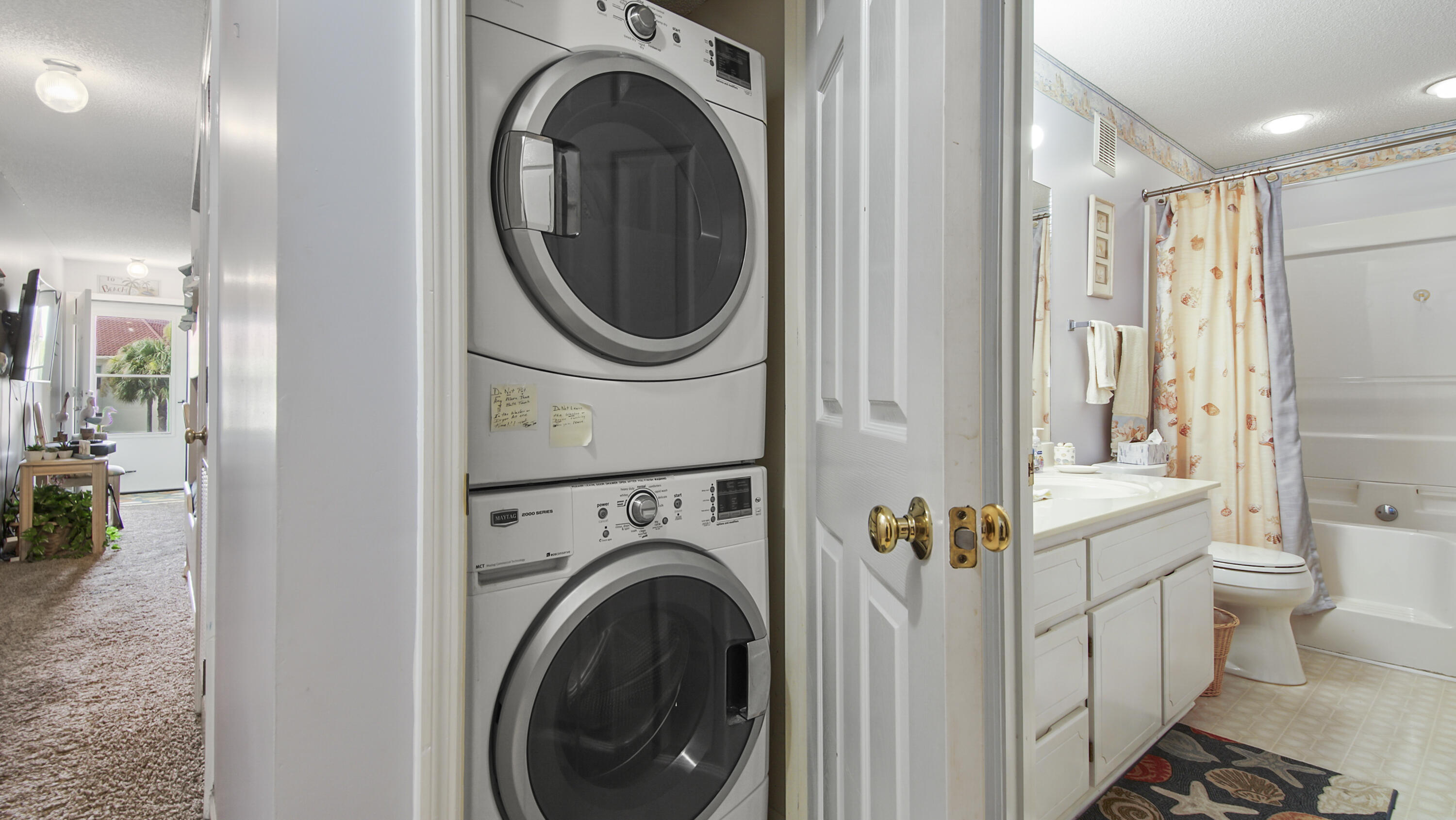17462 Front Beach Road, Unit 54106 Panama City Beach, FL 32413 - Photo 25 of 32 a view of a hallway with washer and dryer