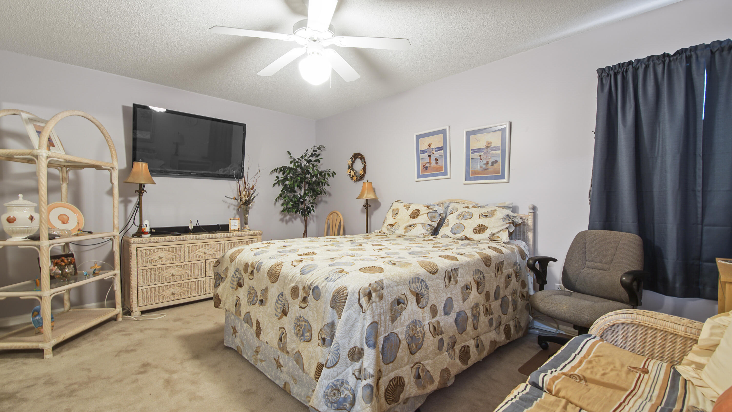 17462 Front Beach Road, Unit 54106 Panama City Beach, FL 32413 - Photo 27 of 32 a spacious bedroom with bed and a flat screen tv