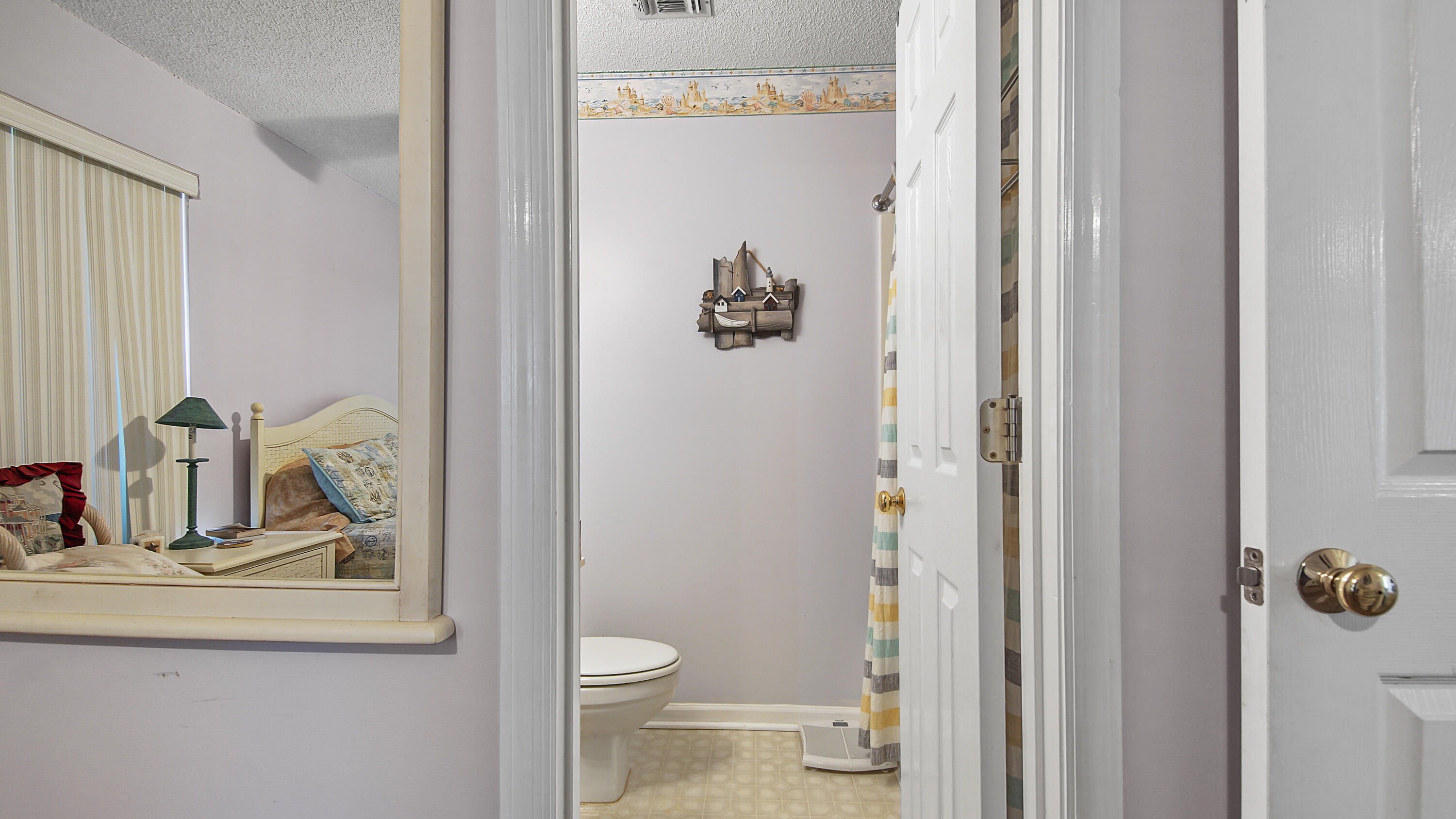 17462 Front Beach Road, Unit 54106 Panama City Beach, FL 32413 - Photo 30 of 32 a bathroom with a toilet a sink and a window