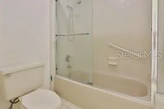 a white bath tub sitting next to a toilet