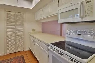a kitchen with stainless steel appliances granite countertop a sink and a microwave