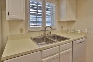 a kitchen with a sink and cabinets