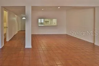 a view of an empty room and a window