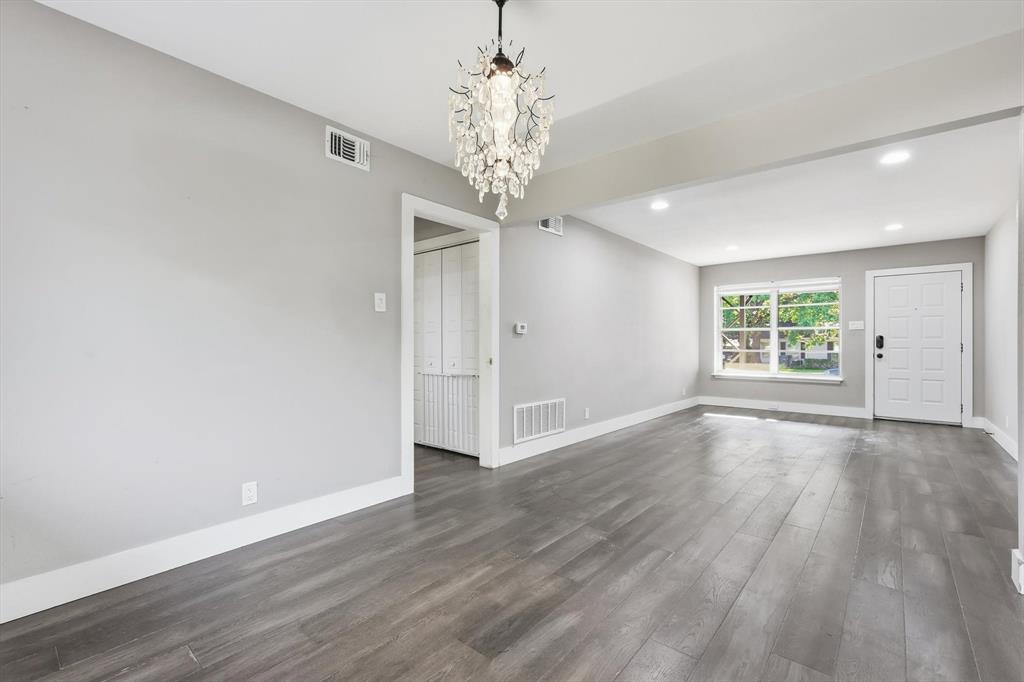 6611 Highgate Lane Dallas, TX 75214 - Photo 11 of 39 Unfurnished living room featuring dark wood-type flooring, a chandelier, and recessed lighting