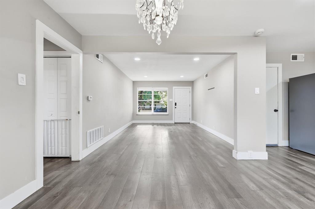 6611 Highgate Lane Dallas, TX 75214 - Photo 15 of 39 Unfurnished living room with light wood-type flooring, recessed lighting, and a chandelier