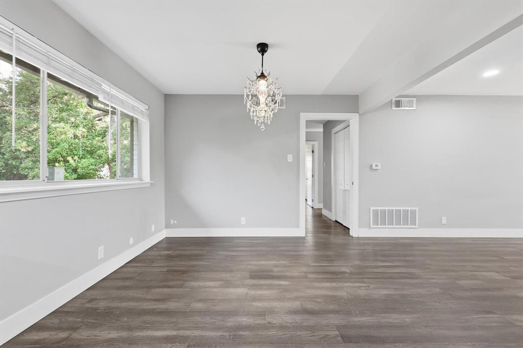 6611 Highgate Lane Dallas, TX 75214 - Photo 17 of 39 Unfurnished dining area featuring a chandelier and dark wood-style floors