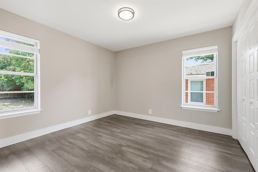 6611 Highgate Lane Dallas, TX 75214 - Photo 23 of 39 Unfurnished bedroom with wood finished floors and a closet