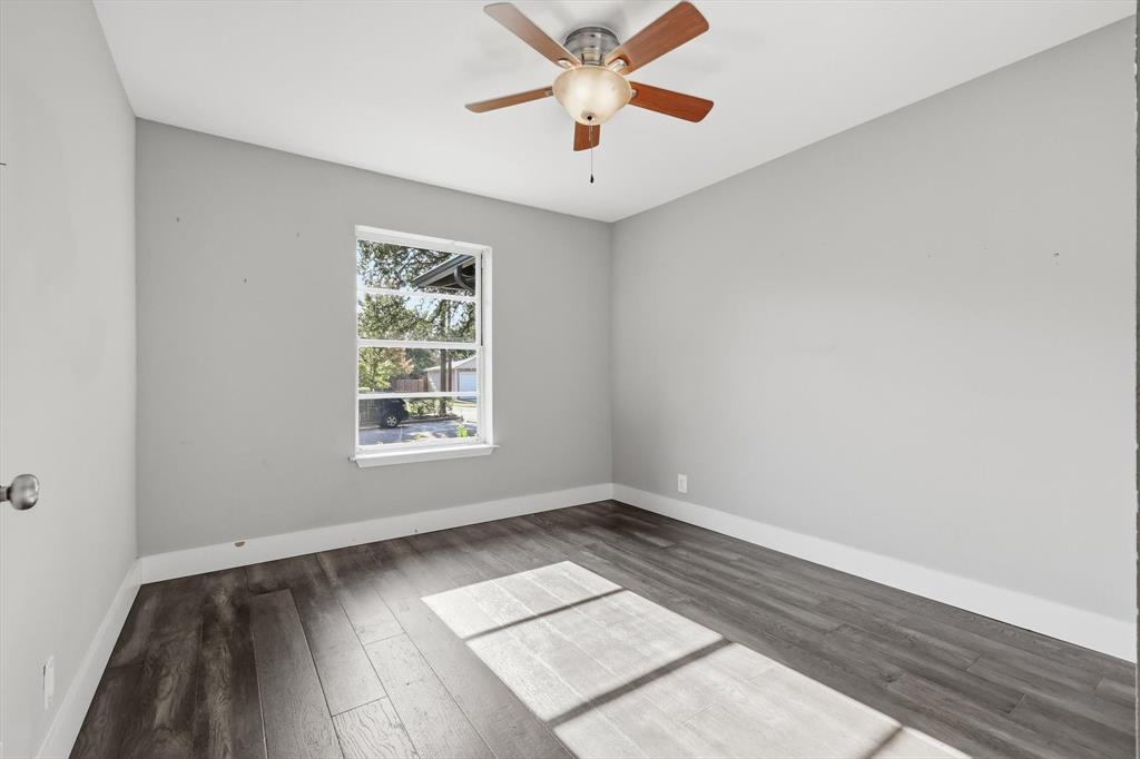 6611 Highgate Lane Dallas, TX 75214 - Photo 26 of 39 Empty room with wood finished floors and ceiling fan
