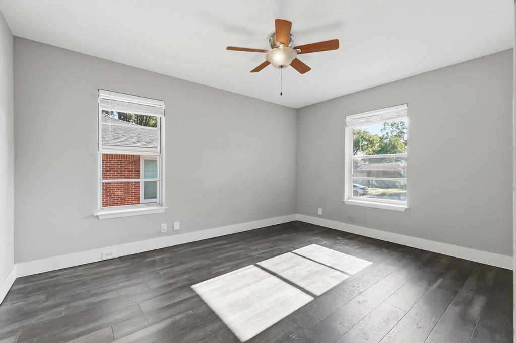 6611 Highgate Lane Dallas, TX 75214 - Photo 29 of 39 Spare room with dark wood-style floors and a ceiling fan