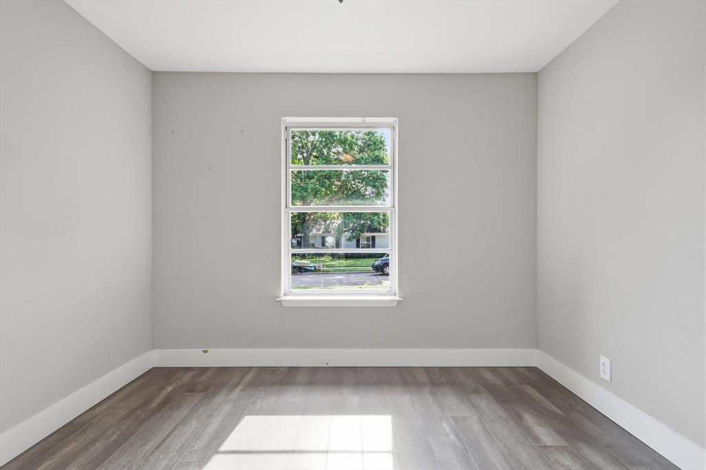 6611 Highgate Lane Dallas, TX 75214 - Photo 33 of 39 Empty room featuring baseboards and wood finished floors