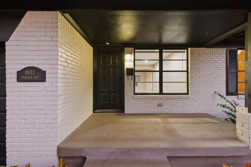 6611 Highgate Lane Dallas, TX 75214 - Photo 4 of 39 Property entrance with brick siding and a porch