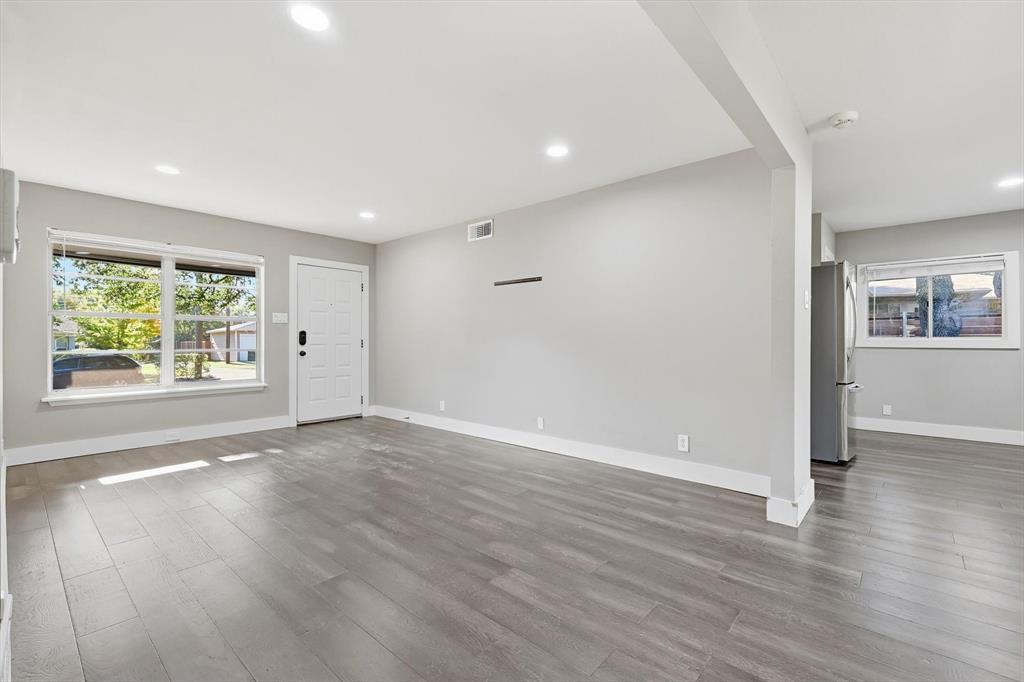6611 Highgate Lane Dallas, TX 75214 - Photo 5 of 39 Unfurnished living room featuring wood finished floors and recessed lighting