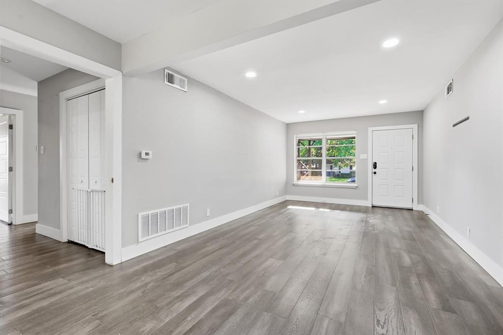 6611 Highgate Lane Dallas, TX 75214 - Photo 10 of 39 Unfurnished living room with wood finished floors and recessed lighting