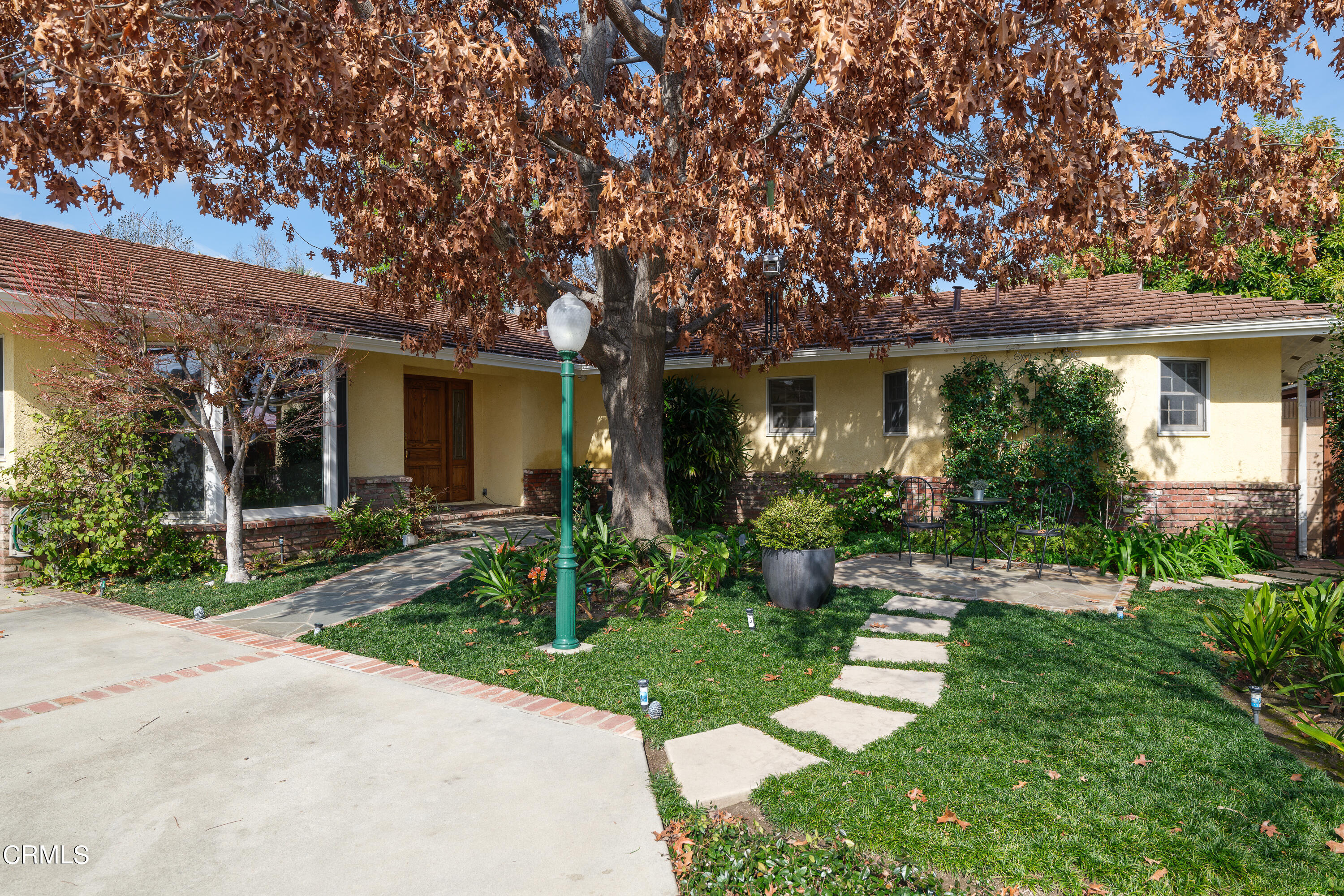 a front view of house with a garden