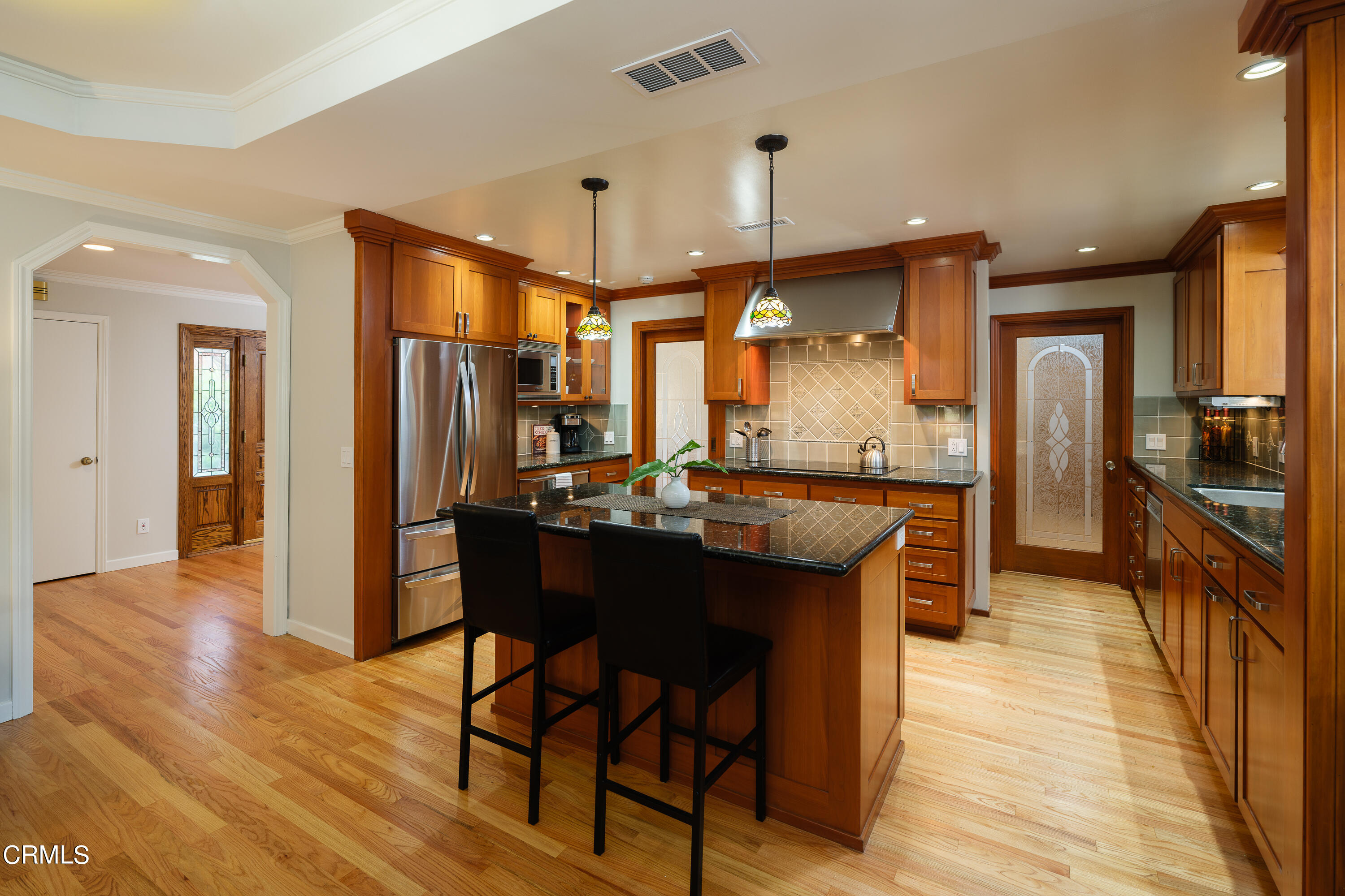 525 Verner Circle Arcadia, CA 91006 - Photo 20 of 45 a kitchen with stainless steel appliances kitchen island granite countertop wooden cabinets and a granite counter top