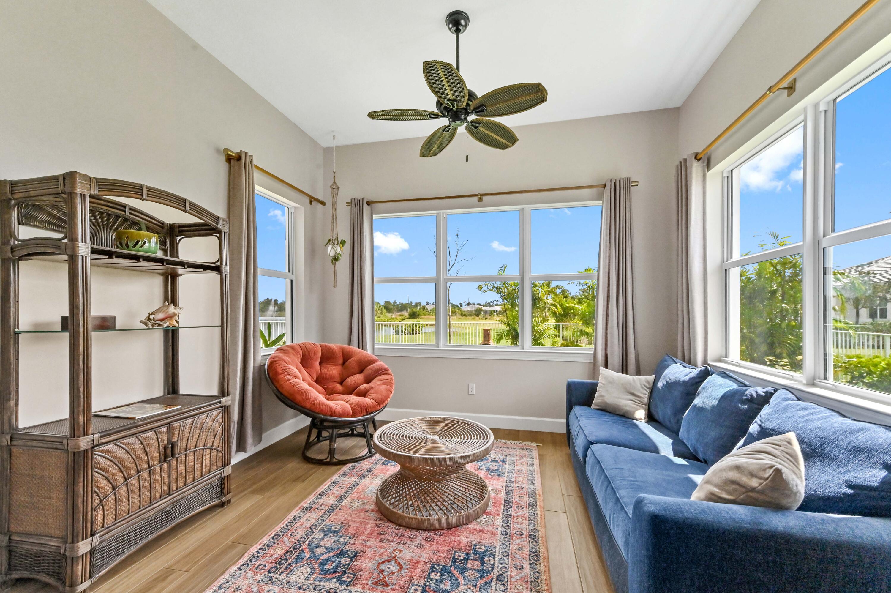 9891 Southwest Legacy Drive Stuart, FL 34997 - Photo 13 of 55 a living room with furniture and a large window