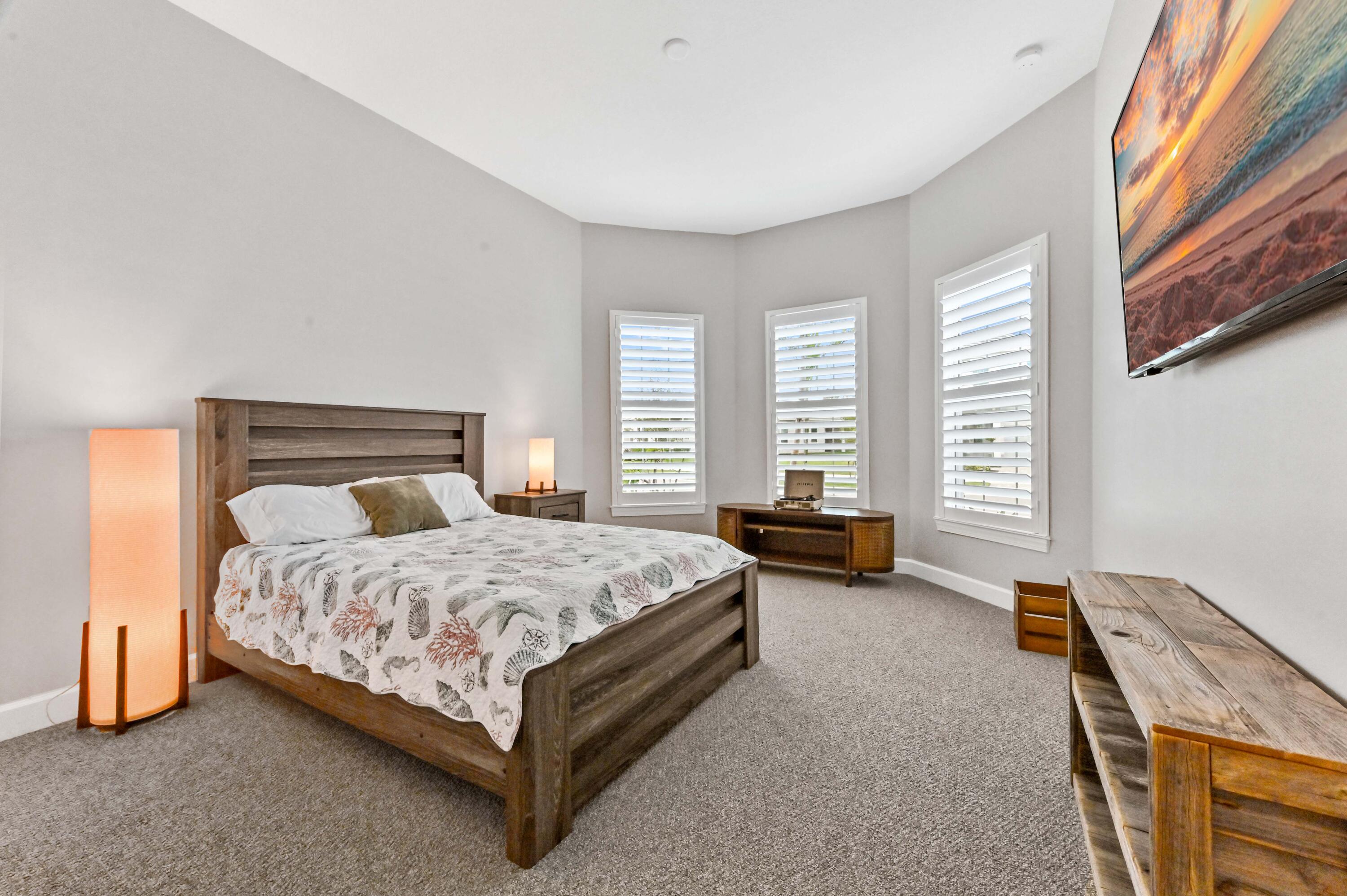 9891 Southwest Legacy Drive Stuart, FL 34997 - Photo 17 of 55 a spacious bedroom with a bed and a couch
