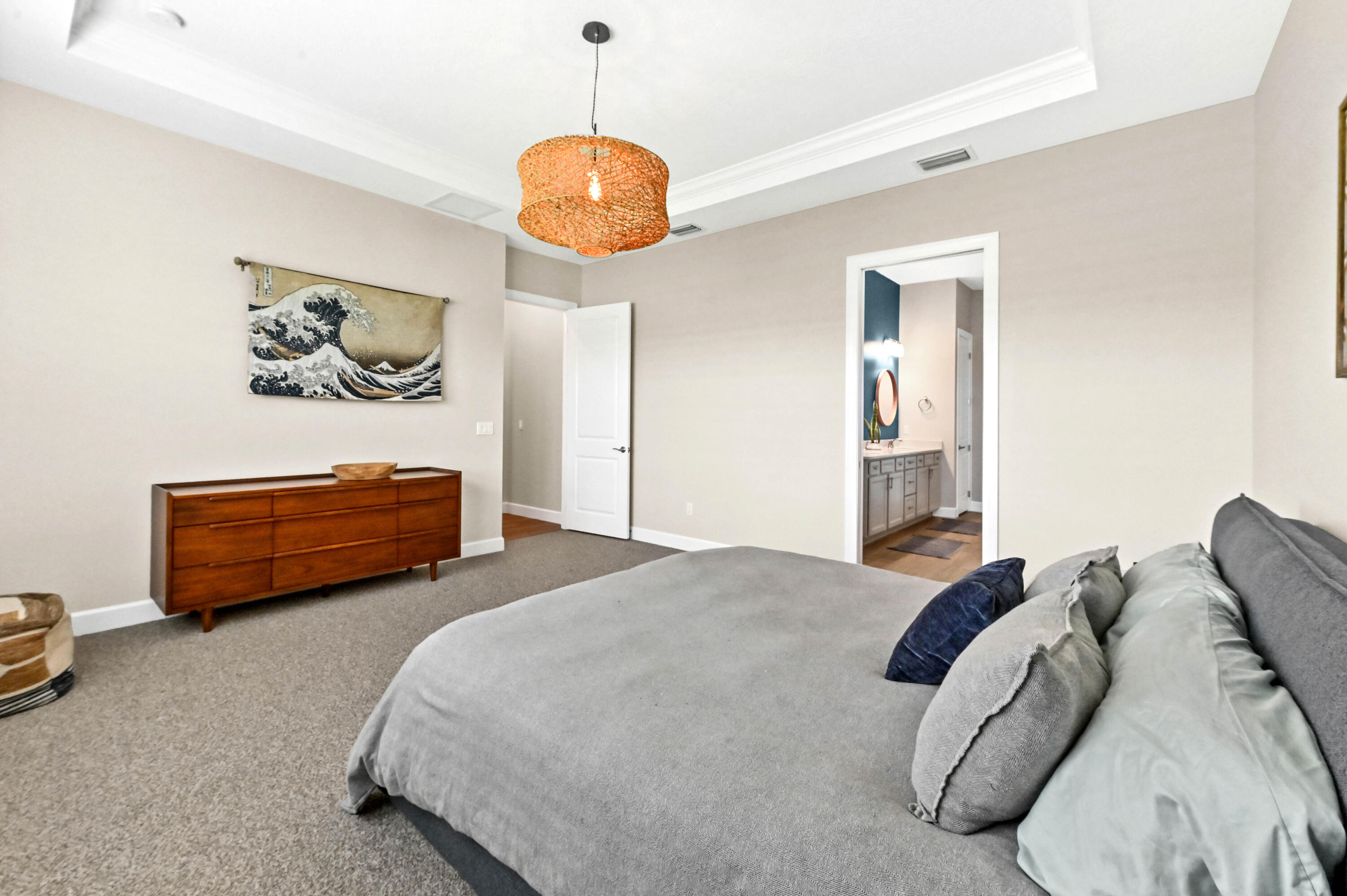 9891 Southwest Legacy Drive Stuart, FL 34997 - Photo 22 of 55 a bedroom with bed and a chandelier