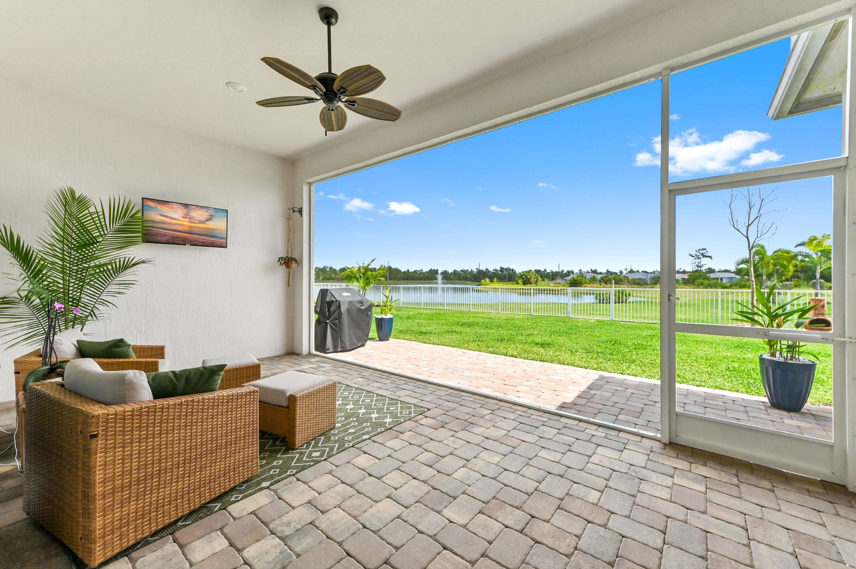 9891 Southwest Legacy Drive Stuart, FL 34997 - Photo 26 of 55 a living room with furniture and a garden