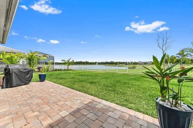 an aerial view of a house with swimming pool and a yard
