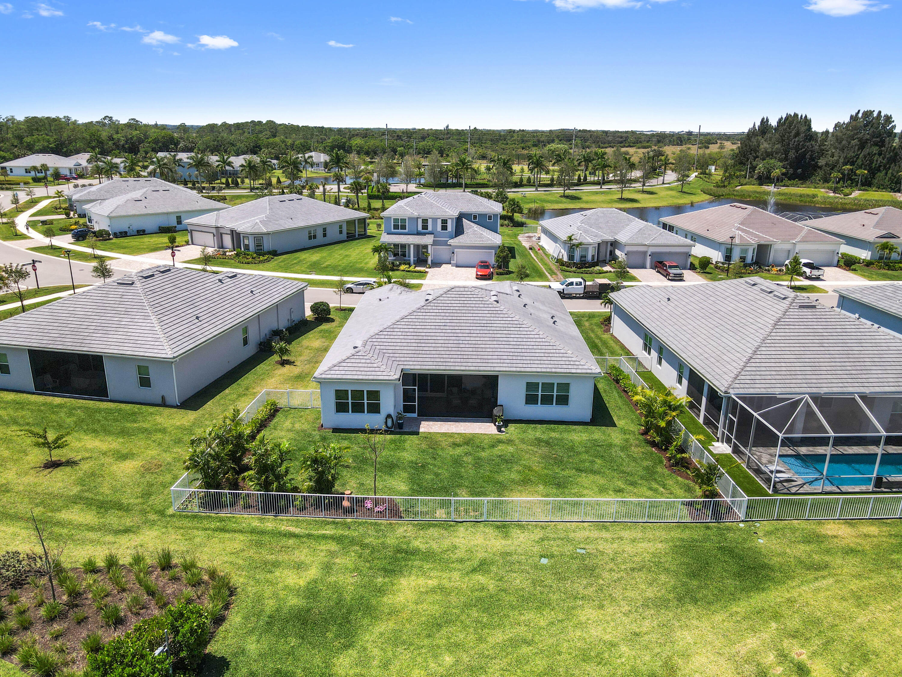 9891 Southwest Legacy Drive Stuart, FL 34997 - Photo 32 of 55 an aerial view of a house with swimming pool and a yard