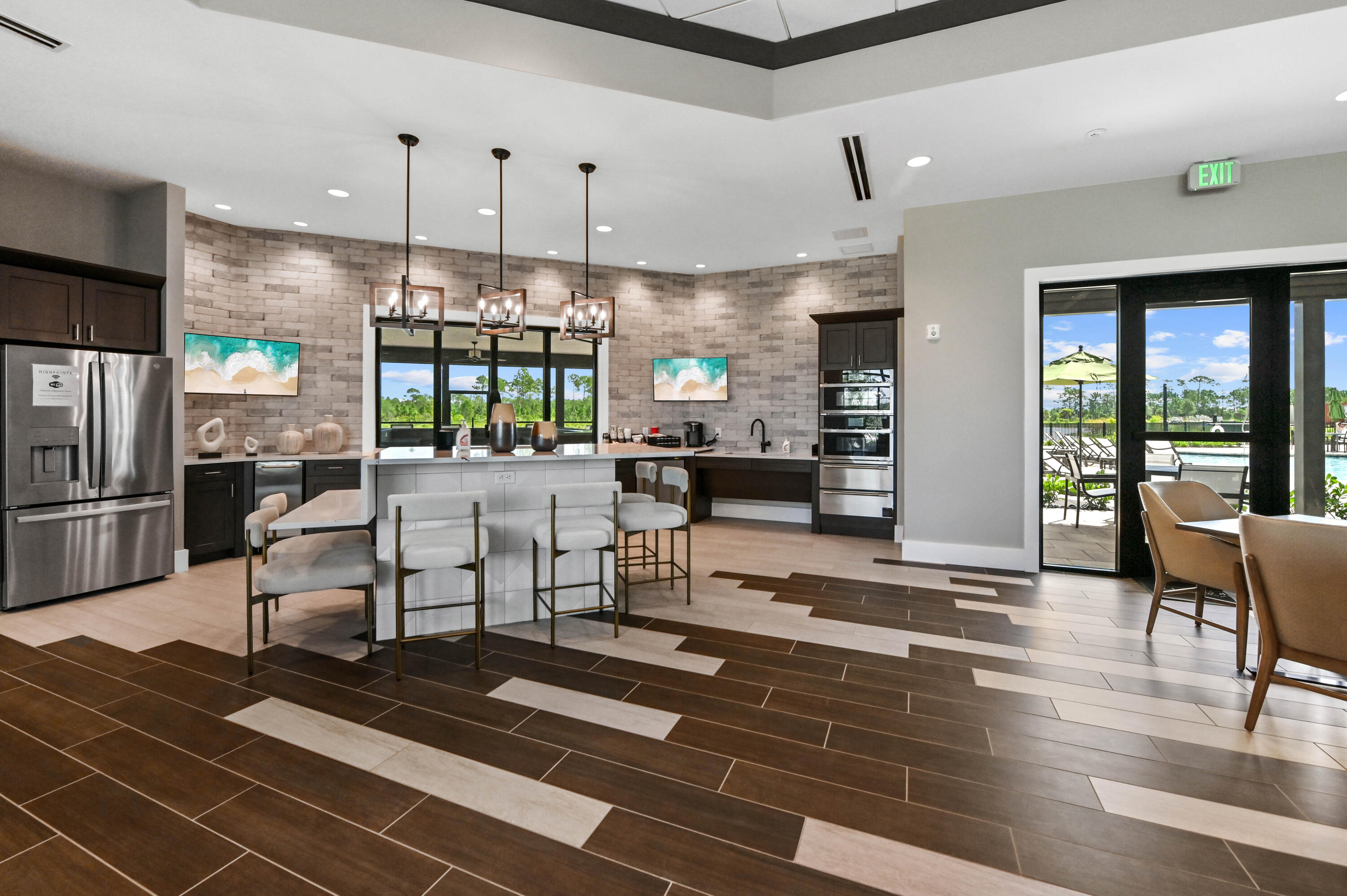 9891 Southwest Legacy Drive Stuart, FL 34997 - Photo 35 of 55 a living room with furniture a large window and stainless steel appliances