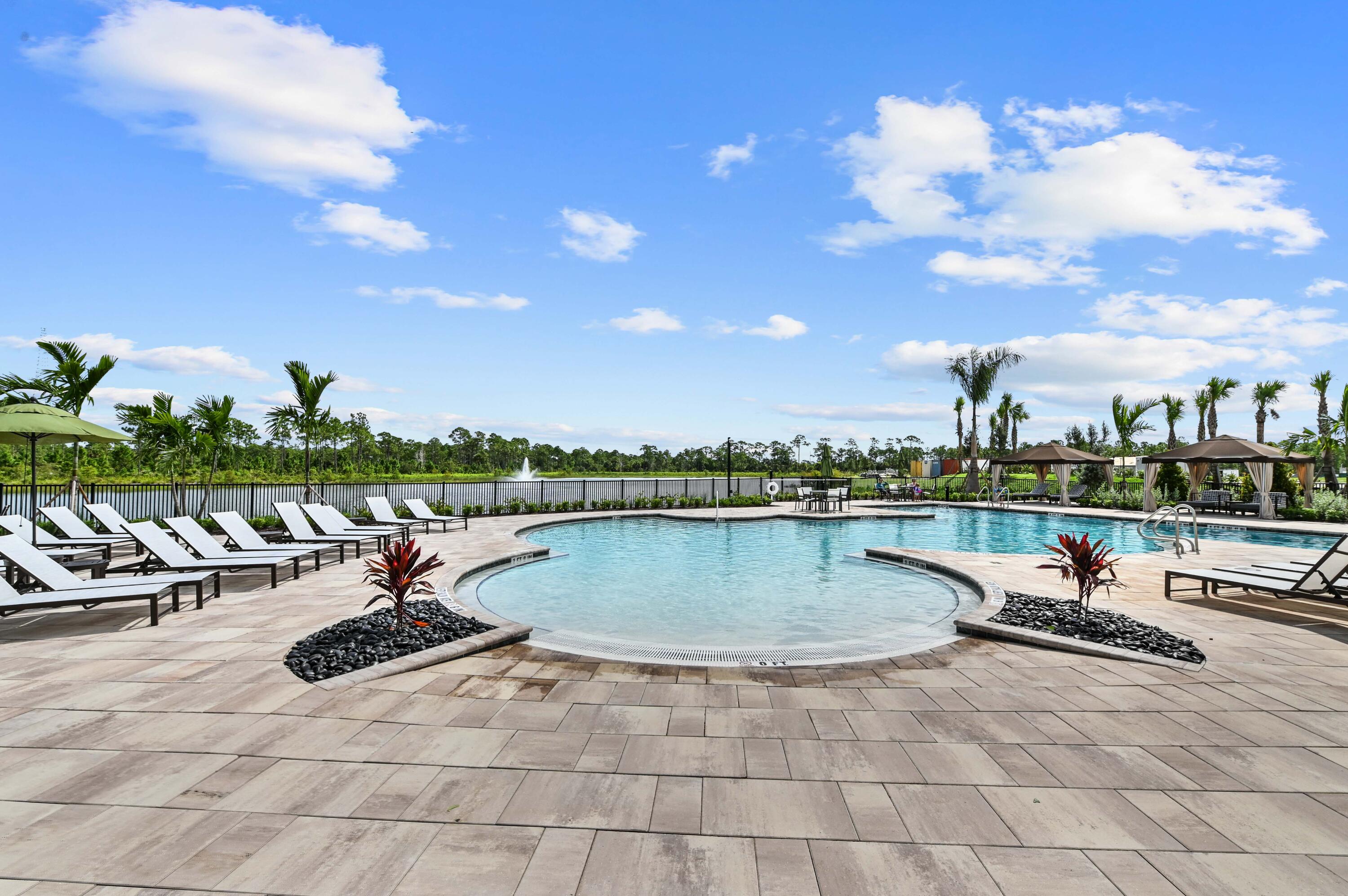 9891 Southwest Legacy Drive Stuart, FL 34997 - Photo 40 of 55 a view of a swimming pool and lounge chair