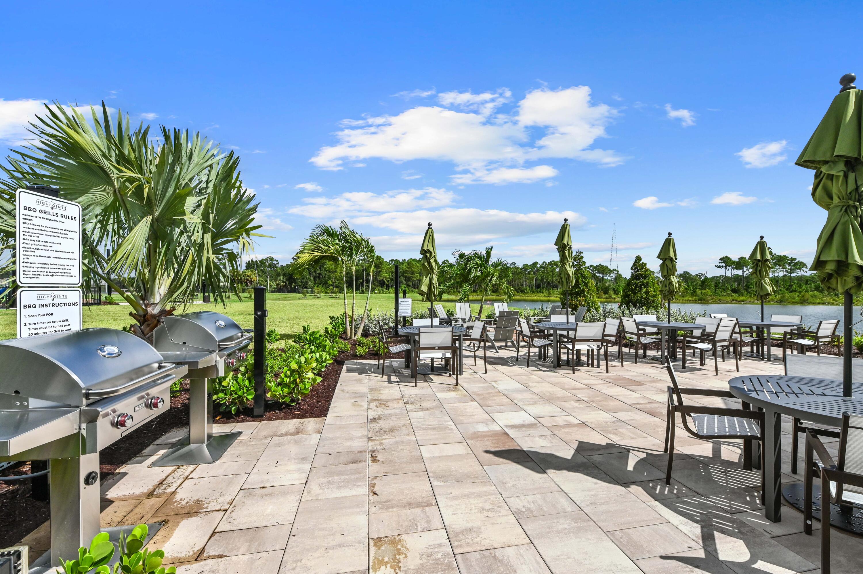 9891 Southwest Legacy Drive Stuart, FL 34997 - Photo 44 of 55 a view of a patio with a dining table and chairs with a patio