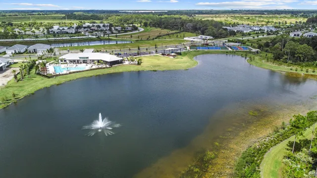 an aerial view of residential houses with outdoor space and lake view