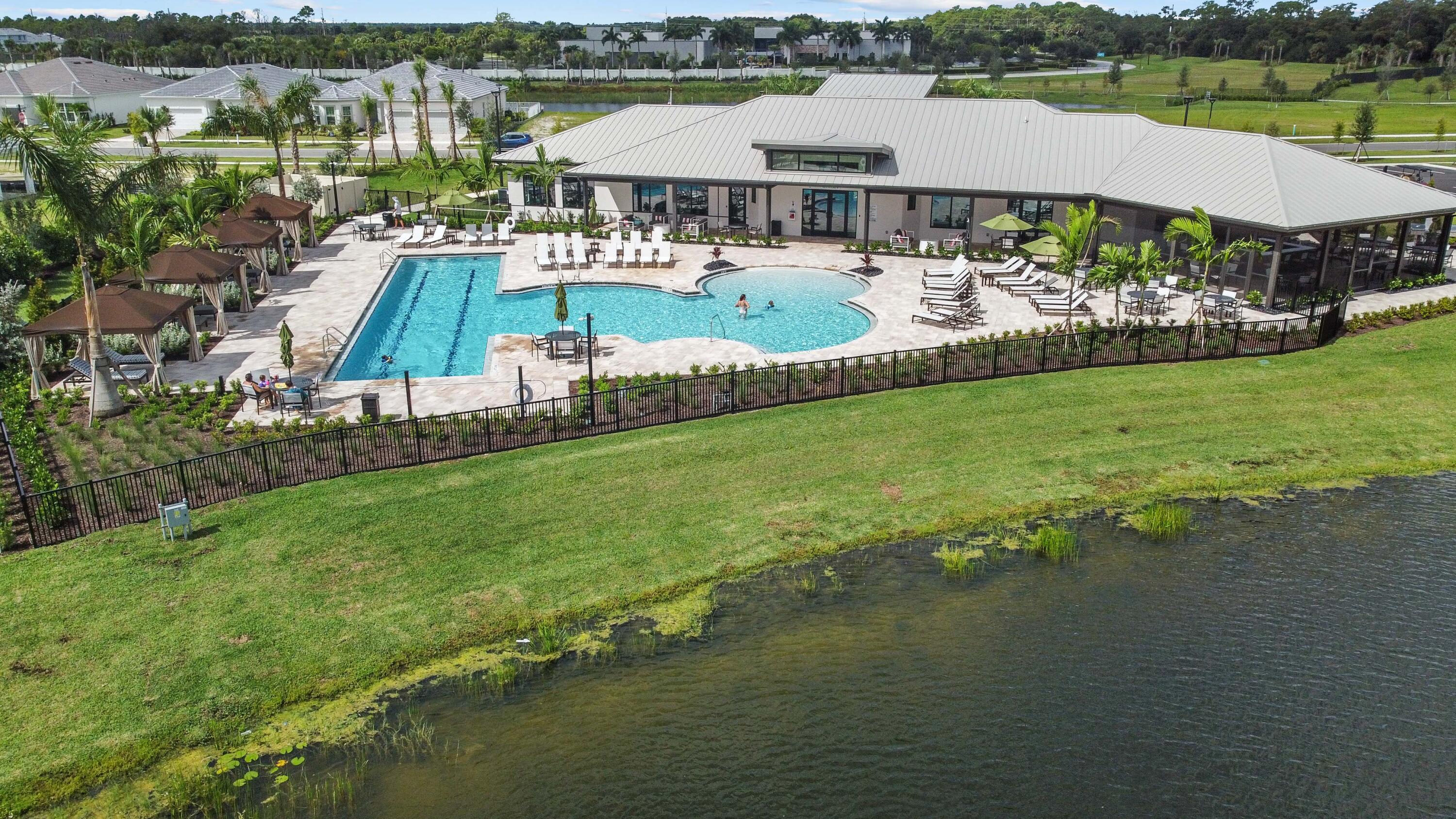 9891 Southwest Legacy Drive Stuart, FL 34997 - Photo 51 of 55 a view of a house with garden and pool