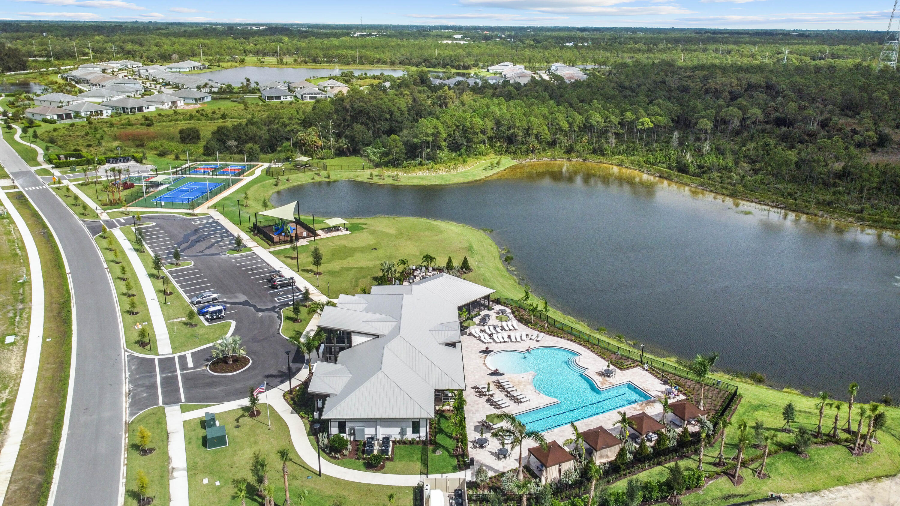 9891 Southwest Legacy Drive Stuart, FL 34997 - Photo 55 of 55 an aerial view of residential houses with outdoor space and lake view